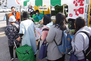 写真：11月17日産業フェスタで餅を手渡す町長